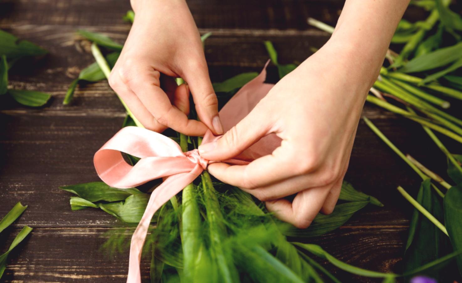 Handcrafted flower arrangement process showing individual attention to detail